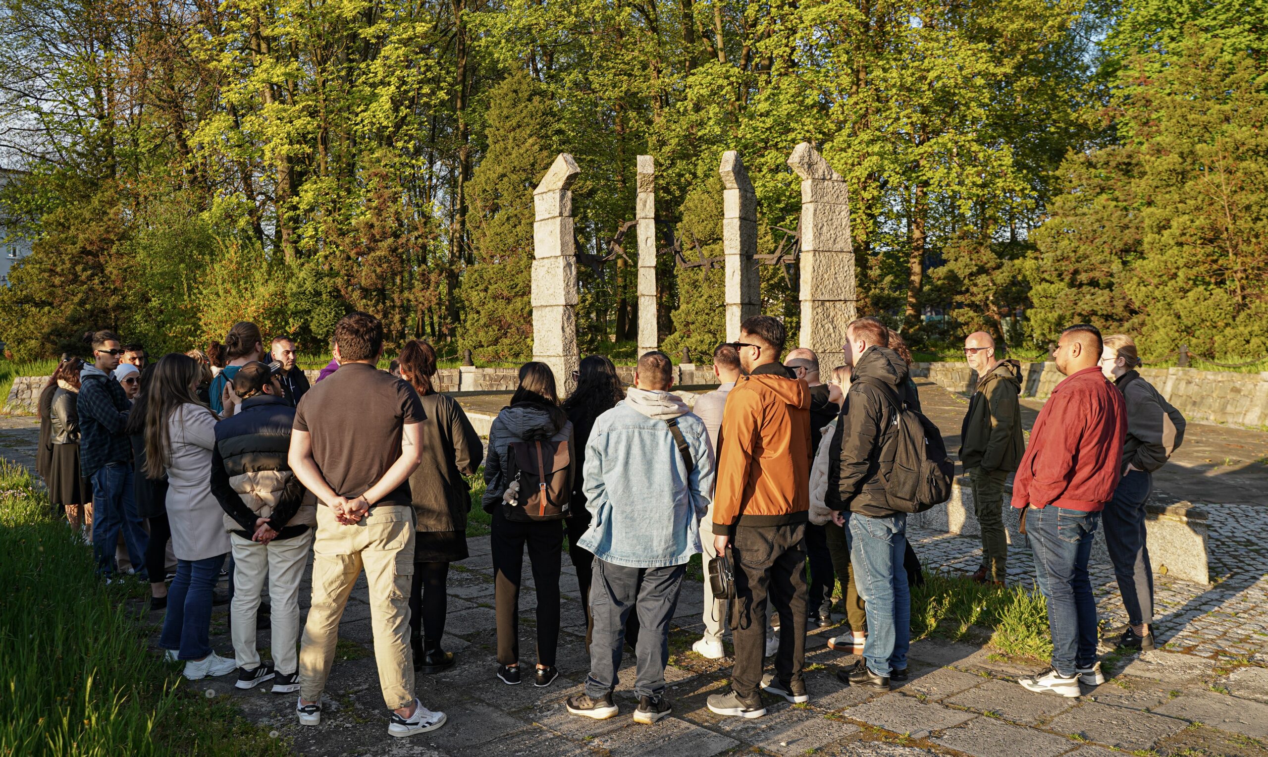 A group stands in front of a monument.